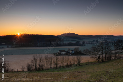 Sunrise over the Jeker valley with the vineyards near Maastricht with a view on the country border and the  typical rolling hills landscape which this area is famous for.