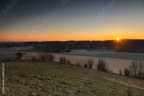 Sunrise over the Jeker valley with the vineyards near Maastricht with a view on the country border and the typical rolling hills landscape which this area is famous for.