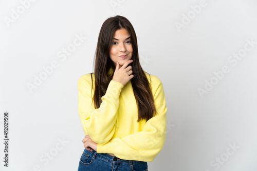 Teenager Brazilian girl isolated on white background thinking