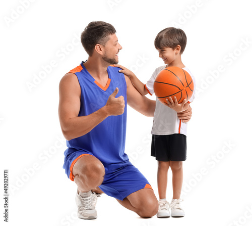 Little boy with ball and his trainer on white background © Pixel-Shot