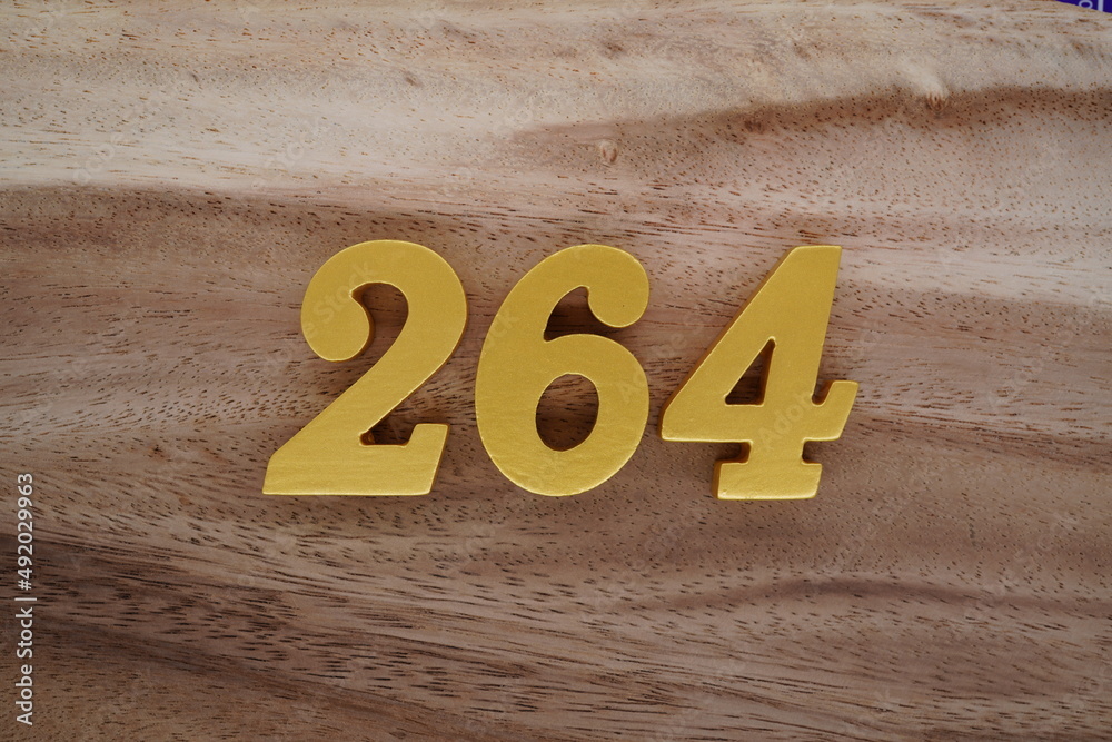 Golden Arabic numerals on a real brown and white wooden floor number ...