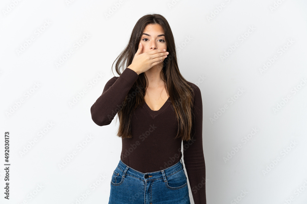 Teenager Brazilian girl isolated on white background covering mouth with hand Teenager Brazilian girl isolated on white background covering mouth with hand