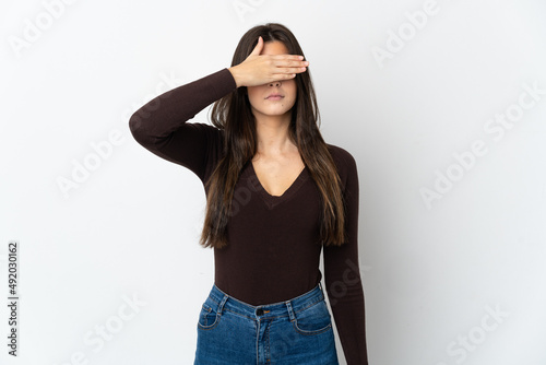 Teenager Brazilian girl isolated on white background covering eyes by hands. Do not want to see something