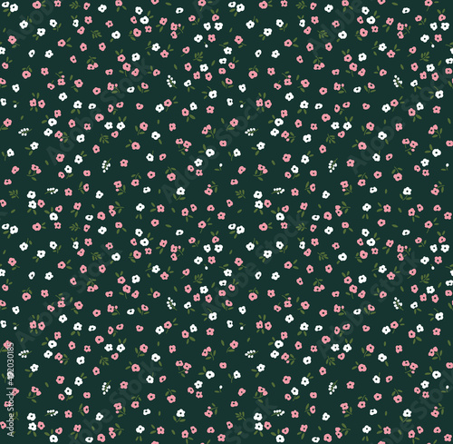 Spring flowers print. Vector seamless floral pattern. Floral design for fashion prints. Endless print made of small white and pink flowers. Elegant template. Dark green background. Stock vector.