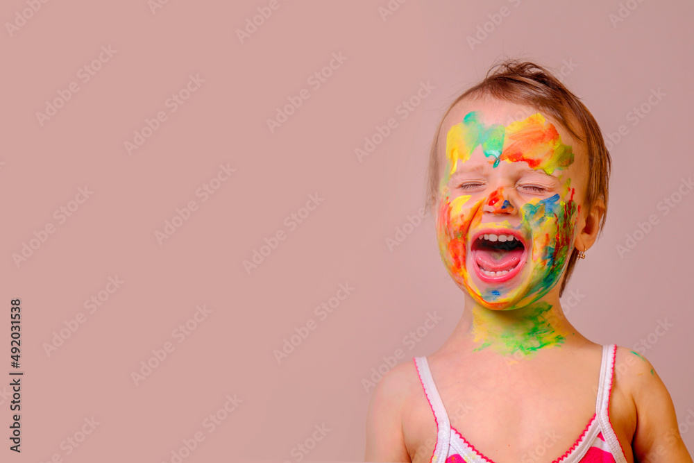 Humorous image of childrens makeup. Beauty, fashion, happy childhood concept. Portrait of beautiful young child girl with painted face and hands. Copy space for text or design. Humorous image of childrens makeup. Beauty, fashion, happy childhood concept. Portrait of beautiful young child girl with painted face and hands. Copy space for text or design.