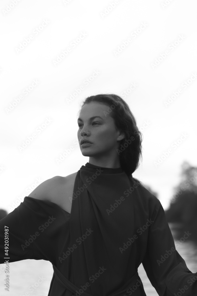 Fototapeta premium Fashion portrait of a beautiful and cute girl in nature in stylish clothes