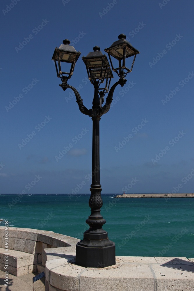 Italy, Salento: Lamp post on the sea.