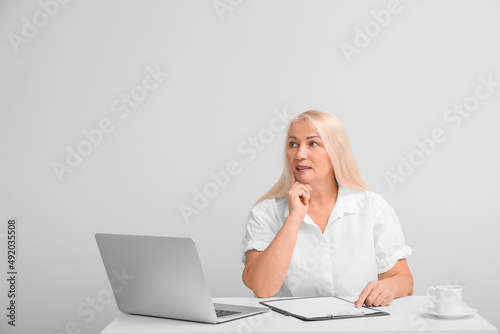 Thoughtful mature secretary...