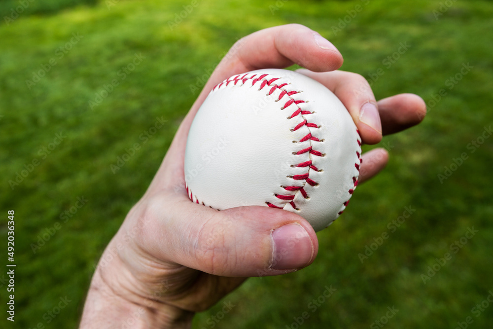 Baseball player gripping a ball. Pitcher hand holding a baseball ready to pitch. Baseball player gripping a ball. Pitcher hand holding a baseball ready to pitch.