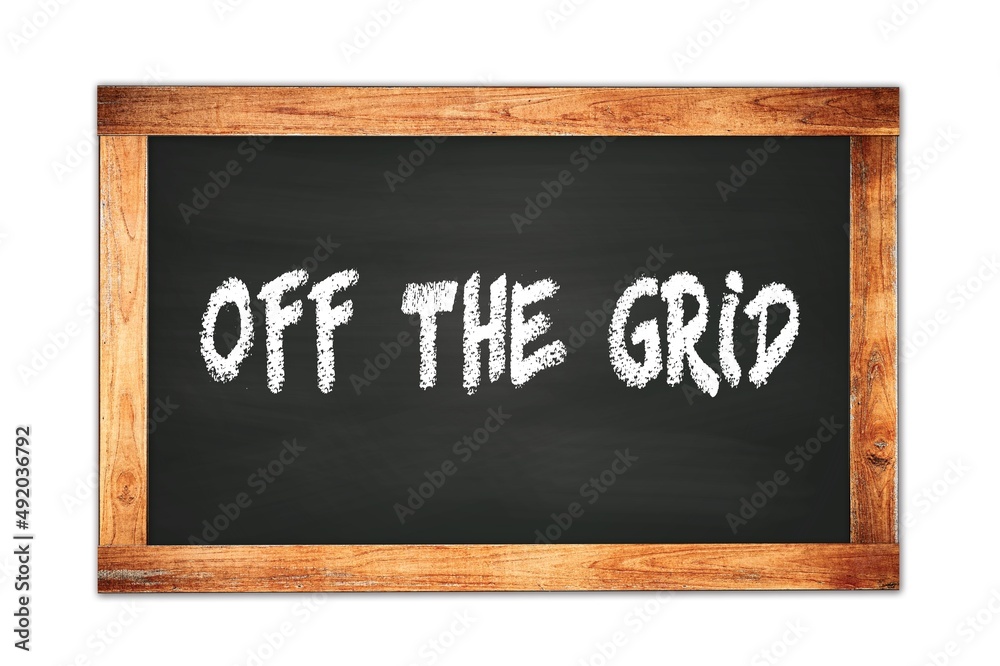 OFF THE GRID text written on wooden frame school blackboard. OFF THE GRID text written on wooden frame school blackboard.
