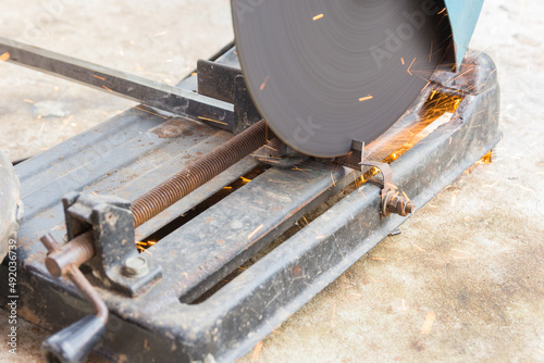 Mechanic is cutting steel with splashes of sparks