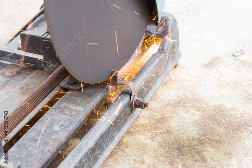 Mechanic is cutting steel with splashes of sparks
