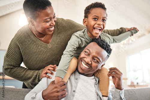 Family time is for laughter and fun. Shot of a happy young family playing together on the sofa at home.