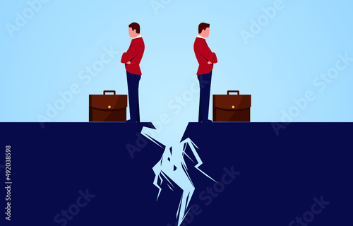 Two businessmen standing back to back across a crack, broken business partnership, partner having problems