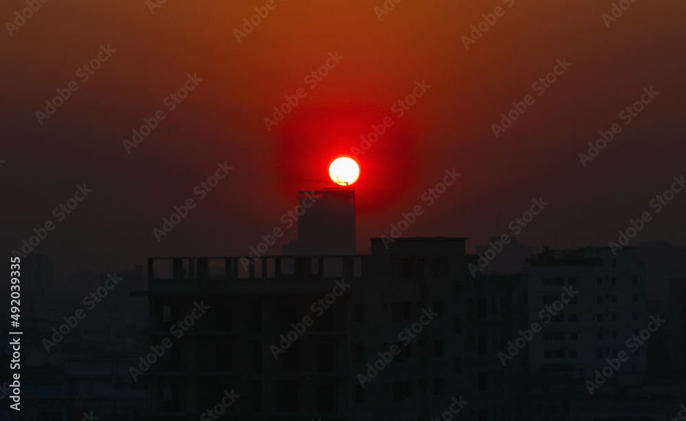 Fototapeta premium Sunset or sunrise at the city with building silhouette. Sunrise cityscape. Copy space.