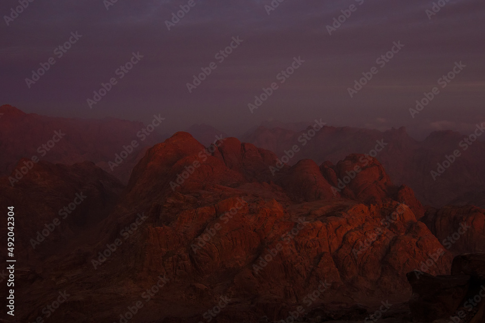 Sunrise on the summit of the Mount Sinai (Mount Horeb, Holy Mount Moses or Gabal Musa), Egypt, North Africa. Low exposure