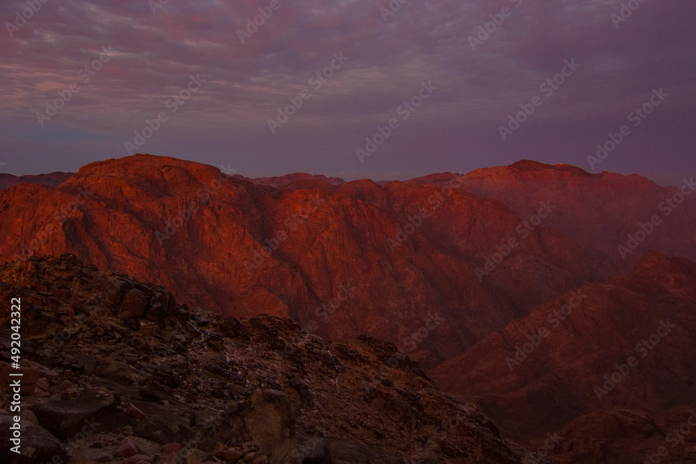 Beautiful sunrise on the summit of the Mount Sinai (Mount Horeb, Holy Mount Moses or Gabal Musa), Egypt, North Africa.