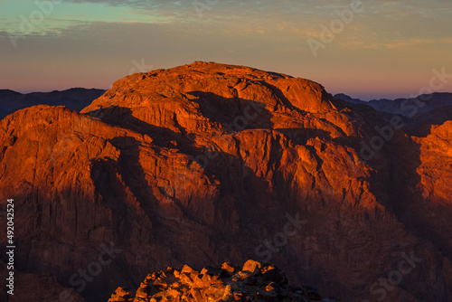 Sunrise on the summit of the Holy Mount Moses (Mount Sinai, Mount Horeb or Gabal Musa), Egypt, North Africa. Low exposure 
