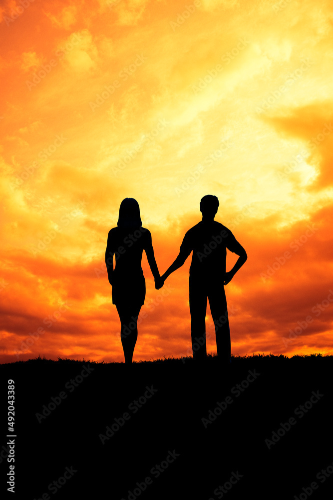 couple hand in hand at sunset