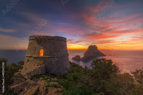 Torre des Savinar and Es Vedra Island , at sunset , with red sky , Ibiza .