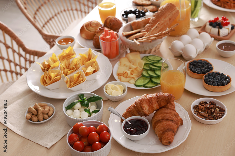 Dishes with different food on table indoors. Luxury brunch Dishes with different food on table indoors. Luxury brunch