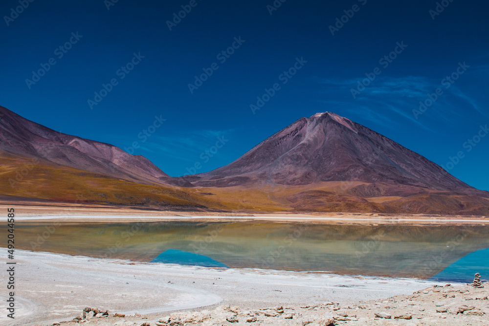 Licancabur volcano with the green lagoon in front in the Bolivian highlands