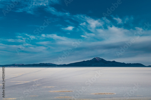 Salt desert with mountain in the background in Bolivia - Uyuni Salt Flat
