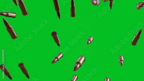 Many bullets falling down on chromakey background. Green screen. photo