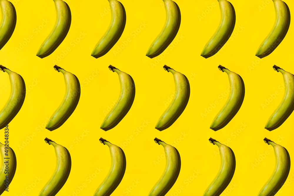Pattern of fresh yellow bananas on yellow background, top view. Pattern of fresh yellow bananas on yellow background, top view.