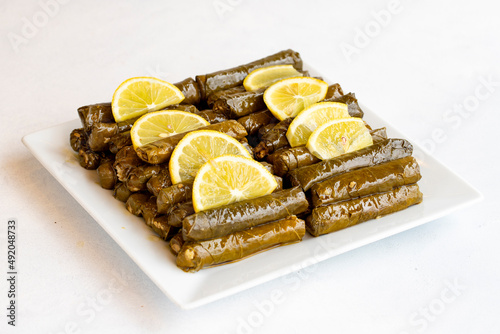 Stuffed leaves with olive oil on a white background. Traditional Turkish cuisine. Local name zeytinyagli yaprak sarma photo