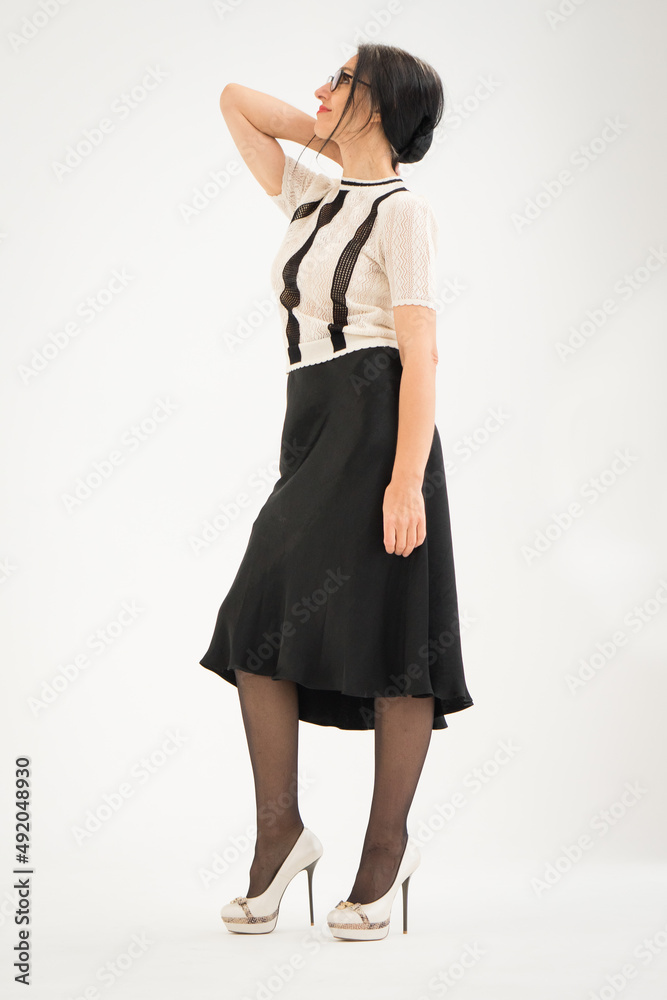 Studio photo of middle aged woman starting getting grey-haired wearing black and white clothes on white background, middle age sexy lady, happy life concept Studio photo of middle aged woman starting getting grey-haired wearing black and white clothes on white background, middle age sexy lady, happy life concept