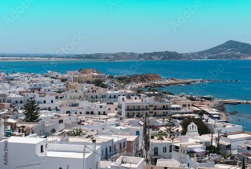 Naxos town view, blue sea, white greek buildings, sunny vacation day, tourism concept