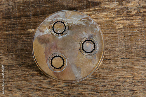 Trafila in ottone di pasta fresca, isolata su sfondo legno photo