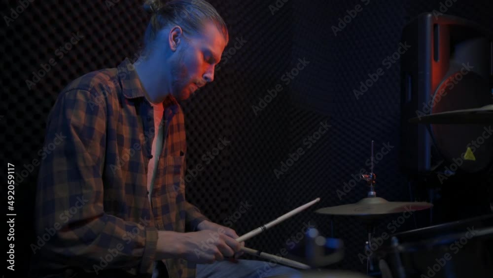 man musician playing on drums in music studio man musician playing on drums in music studio