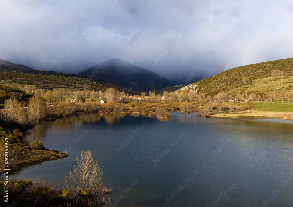 Mountainous town in winter beside the  Camporredondo Reservoir, Triollo, Palencia, Spain