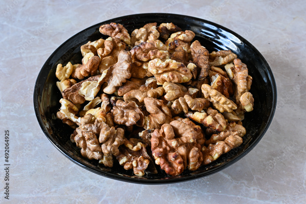walnuts in a plate, walnut kernels, peeled walnuts. walnuts in a plate, walnut kernels, peeled walnuts.