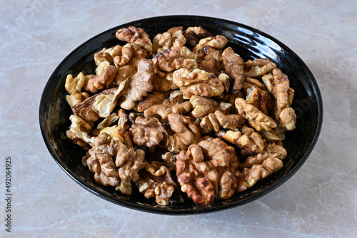 walnuts in a plate, walnut kernels, peeled walnuts.