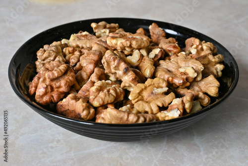 walnuts in a plate, walnut kernels, peeled walnuts.