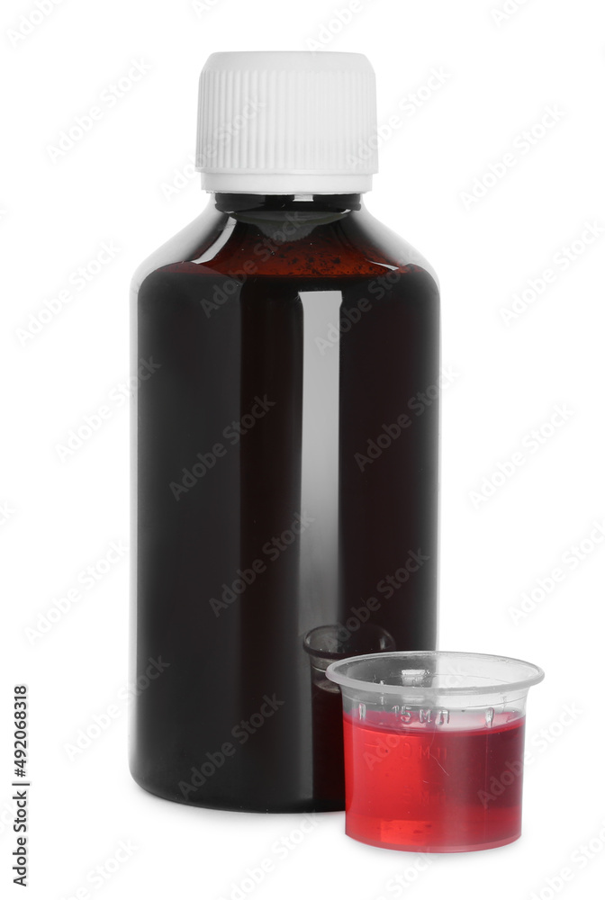 Bottle of cough syrup and measuring cup on white background Bottle of cough syrup and measuring cup on white background