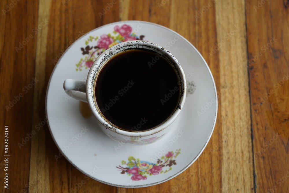 Fototapeta premium a cup of coffee on a wooden table