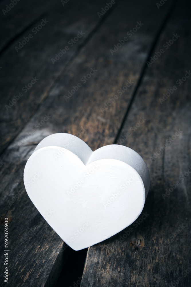 Fototapeta premium White heart in crack on old wooden floor.