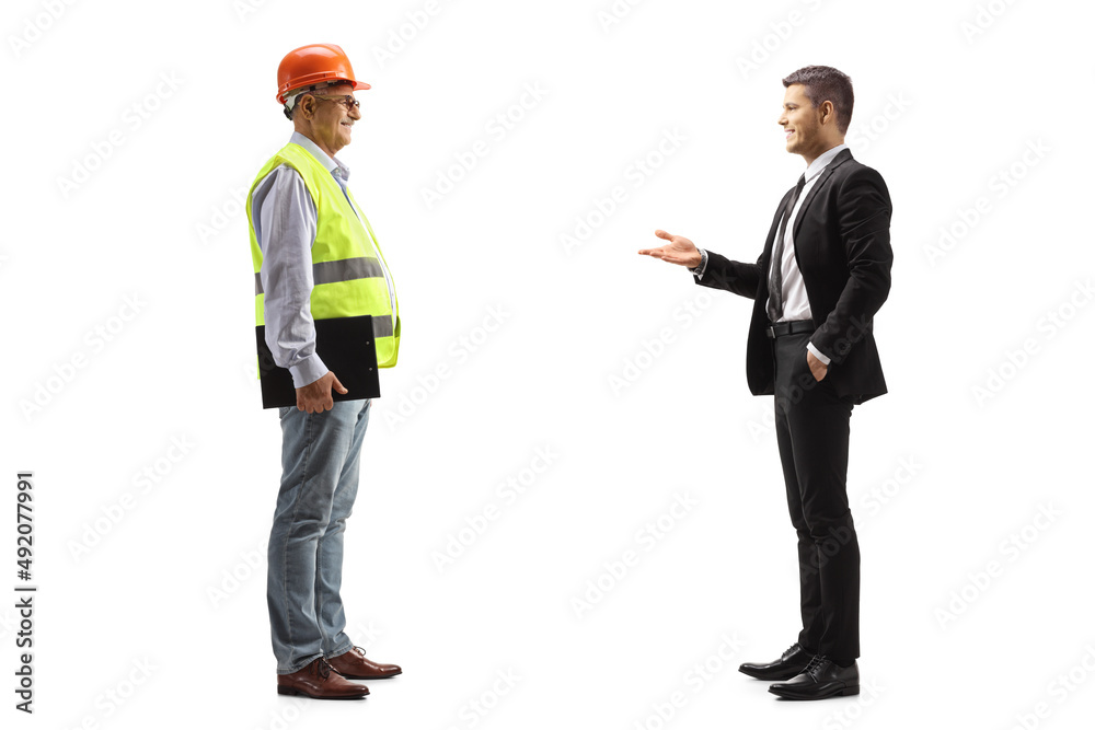 Young businessman talking to a mature engineer Young businessman talking to a mature engineer