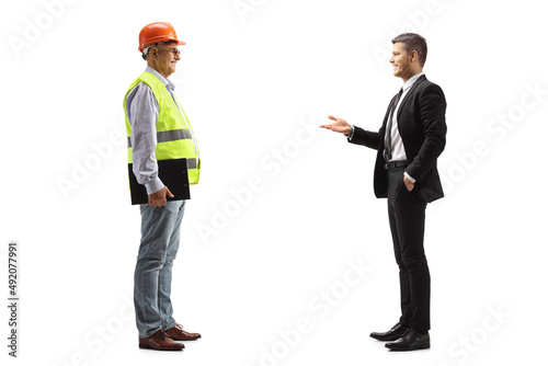 Young businessman talking to a mature engineer