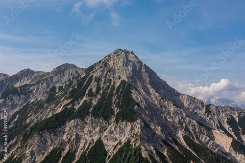 Scenic view from Ferlacher Spitze on summit mount Mittagskogel in the Karawanks in Carinthia, Austria. Borders between Austria, Slovenia, Italy. In back Julian Alps and the Triglav National Park.