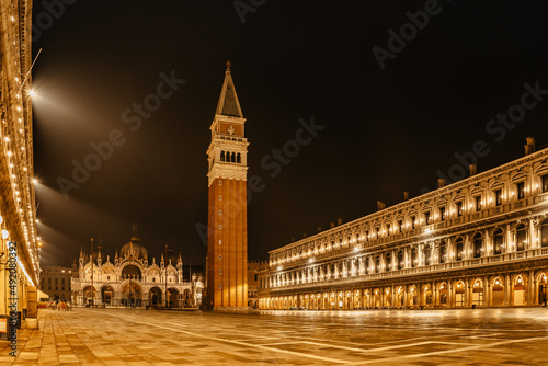 Illuminated San Marco square with Basilica of Saint Mark and Bell Tower at night,Venice,Italy.Late evening at popular tourist destination.World famous Venice landmarks.Postcard view,travel scenery