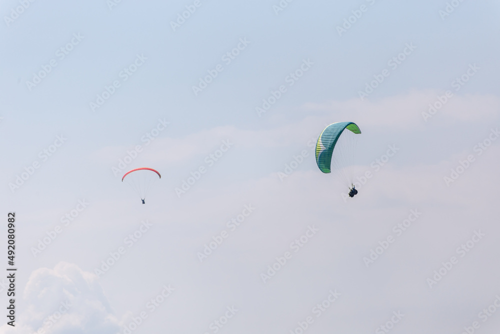 Paraplaners with beautiful blue sky and clounds in the background Paraplaners with beautiful blue sky and clounds in the background