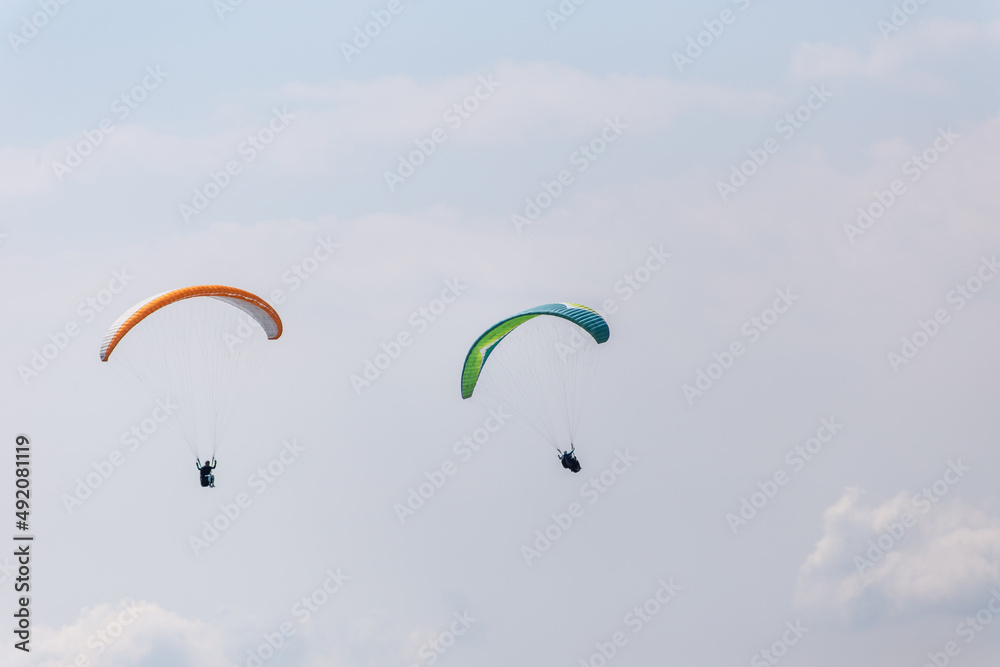 Paraplaners with beautiful blue sky and clounds in the background Paraplaners with beautiful blue sky and clounds in the background