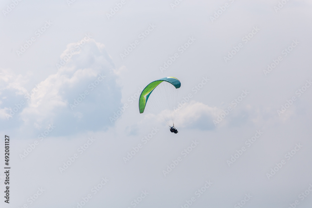 Paraplaners with beautiful blue sky and clounds in the background Paraplaners with beautiful blue sky and clounds in the background