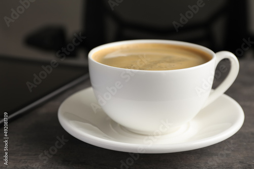 Cup of americano on grey table in office  closeup. Coffee Break