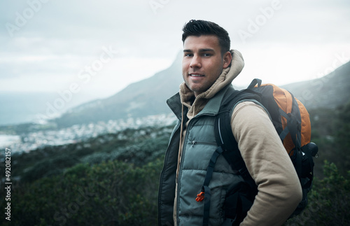 It feels good to be lost in the right direction. Portrait of a young man hiking through the mountains.